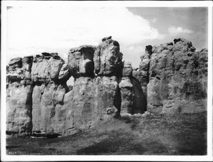 Rock walls of Mesa Encantada upon which the Acoma Pueblo sits concealed from view, ca.1900