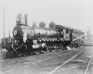 Decorated locomotive engine used to transport President Theodore Roosevelt to La Fiesta in Los Angeles, May 8, 1903