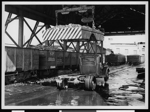 Truck being unloaded in an unidentified rail yard