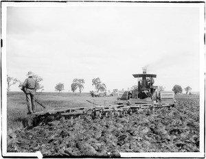 Three men operating a steam plow in a field in Hanford, Kings County, California, ca.1900