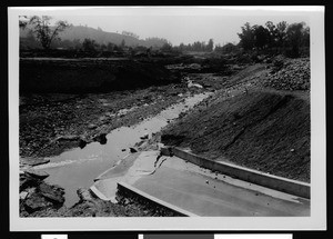 Wide dirt ditch after flood damage, 1938