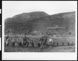 Men working on the aqueducts, showing workers with sections of pipe