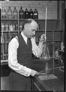 Man adjusting a burner under a beaker