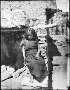 Young Hopi Indian girl sitting outside, ca.1900