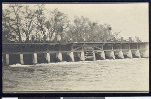 Flood control device or flume (?) over a river, ca.1910