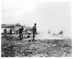 Men firing a cannon for a Harbor Day celebration in San Pedro, ca.1889