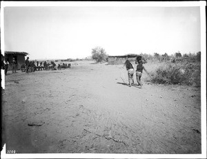 Two young Yuma Indian men playing the pole and hoop game, ca.1900