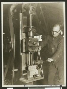 Man drilling cylinders for air compressors in a Compton factory, February 1927