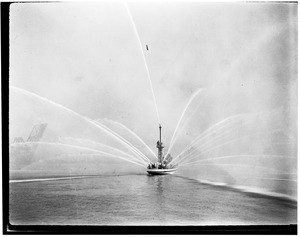 View of the Los Angeles City #2 fireboat, spewing streams of water, 1927