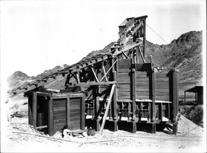 Rail car at top of the ore dump at mine run by Free Gold Mining Company, Hedges, California, ca.1905