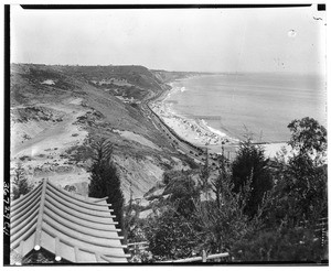 View of the Pacific Coast Highway and surrounding ocean and hills from atop a hill