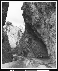 Automobile under a rocky overhand, Canada, ca.1930-1939