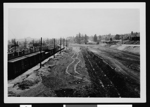 View along railroad tracks and what appears to be a water-flow channel