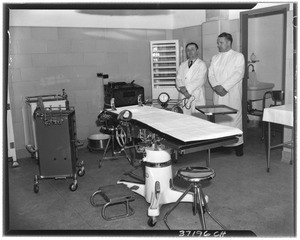 Two medical professionals standing in a prison's infirmary (presumably at Terminal Island Federal Prison)