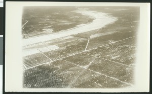 Aerial view of flooding of the Santa Ana River near Colton, showing a break in the levee, ca.1930