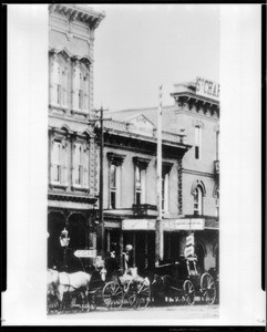 Exterior view of the first location of the Farmers and Merchants Bank on Main Street north of the St. Charles Hotel in Los Angeles, ca.1885