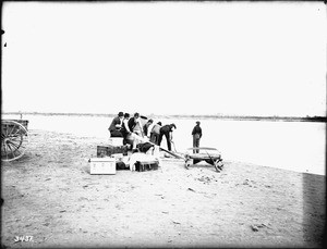 Small outboard being launched at Needles in the Colorado River, ca.1900