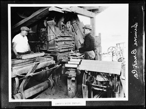 Two men tending a machine at Simon's Brick Compnay