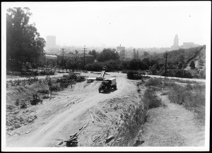 View of the dirt lanes of the North Figueroa Street construction site, showing a truck, looking south, February 1936