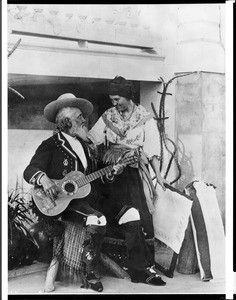 Portrait of Don Antonio Coronel playing a guitar as Dona Mariana Coronel stands by his side, ca.1886