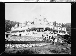 Exterior view of the Echo Mountain House with people on the porch