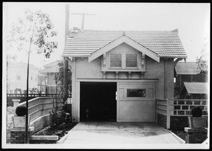 Exterior view of a garage with a room above