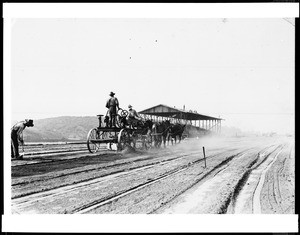 View of workmen and horse-drawn equipment during the construction of the grandstand at the Los Angeles County Fair Grounds in Pomona, 1922