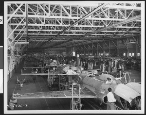 An unidentified aircraft assembly manufacturing factory assembly line, showing F-80 airplanes, ca.1945-1950