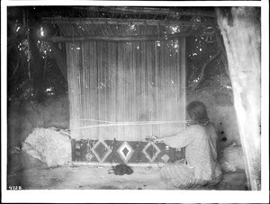 Navajo woman at her loom weaving a blanket, ca.1900