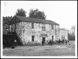 Group of men and a burro in front of the Campo stage station and store, ca.1905