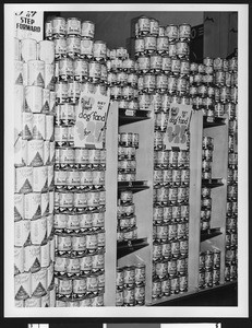 Display of cans of Red Heart dog food, ca.1935