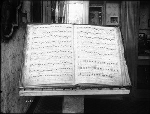 Large music book open to "A Vesper