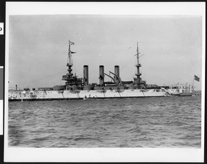 Port profile of the U.S.S. Vermont with several small boats alongside, 1908