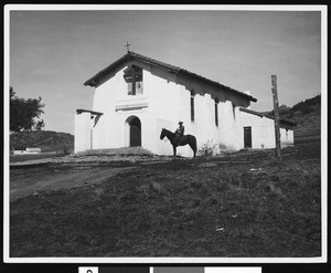 Man on horse in front of Asistencia Santa Ysabel's Indian church at Mission San Diego Alcala, 1940