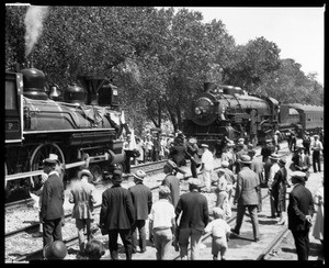 Crowd of onlookers on the tracks in front of two engines at the recreation of the Southern Pacific Line's completion, September 5, 1926