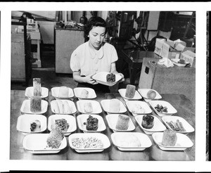 Woman inspecting frozen food in Los Angeles, 1930-1940