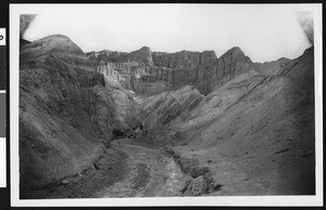 Man and automobile on the west side of Black Range in Death Valley, ca.1900-1950