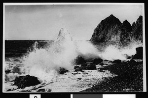 Surf breaking along the shore rocks of Sugar Loaf Island in Avalon Harbor, ca.1900