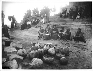 People gathered around jugs of emetic brought by the Snake Priests in the Hopi Indian village of Mishongnovi, ca.1901