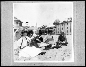 People sitting in the sand on the beach in Santa Monica, 1907