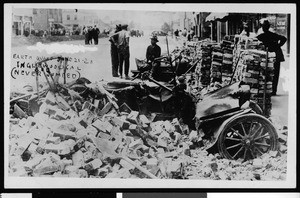 Earthquake damage in Inglewood, showing a crushed automobile, June 21, 1920