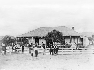 Exterior view of the Rubottom Hotel and Stage Station, showing bystanders, Spadra, 1867