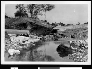 Flood-damaged street, showing large amounts of debris