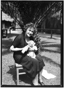 Woman holding a lion cub on Gay's Lion Farm, December 1, 1931