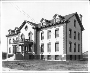 Exterior view of three-story Federal-style German Hospital with a portico entrance and a balcony above the portico, Boyle Heights