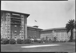 Exterior view of the Ambassador Hotel in Los Angeles, showing a golf course in the foreground, ca.1920-1929