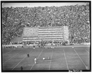 Fans forming an American flag at a football game in the Los Angeles Memorial Coliseum