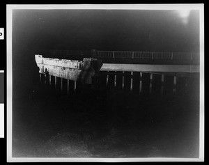 Night shot of a damaged bridge at the Warner Brothers-First National Studios, 1938