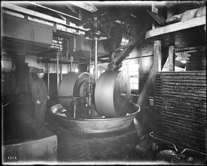 A worker next to an olive mill, California, ca.1900