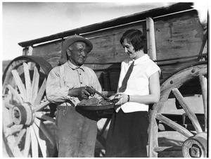 Man pointing a gun near a woman